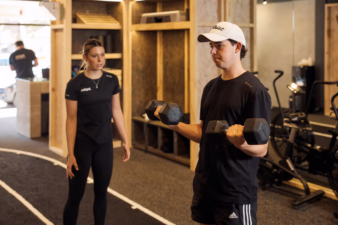Client completing a dumbbell set used to illustrate Adapt's condition articles, North Sydney