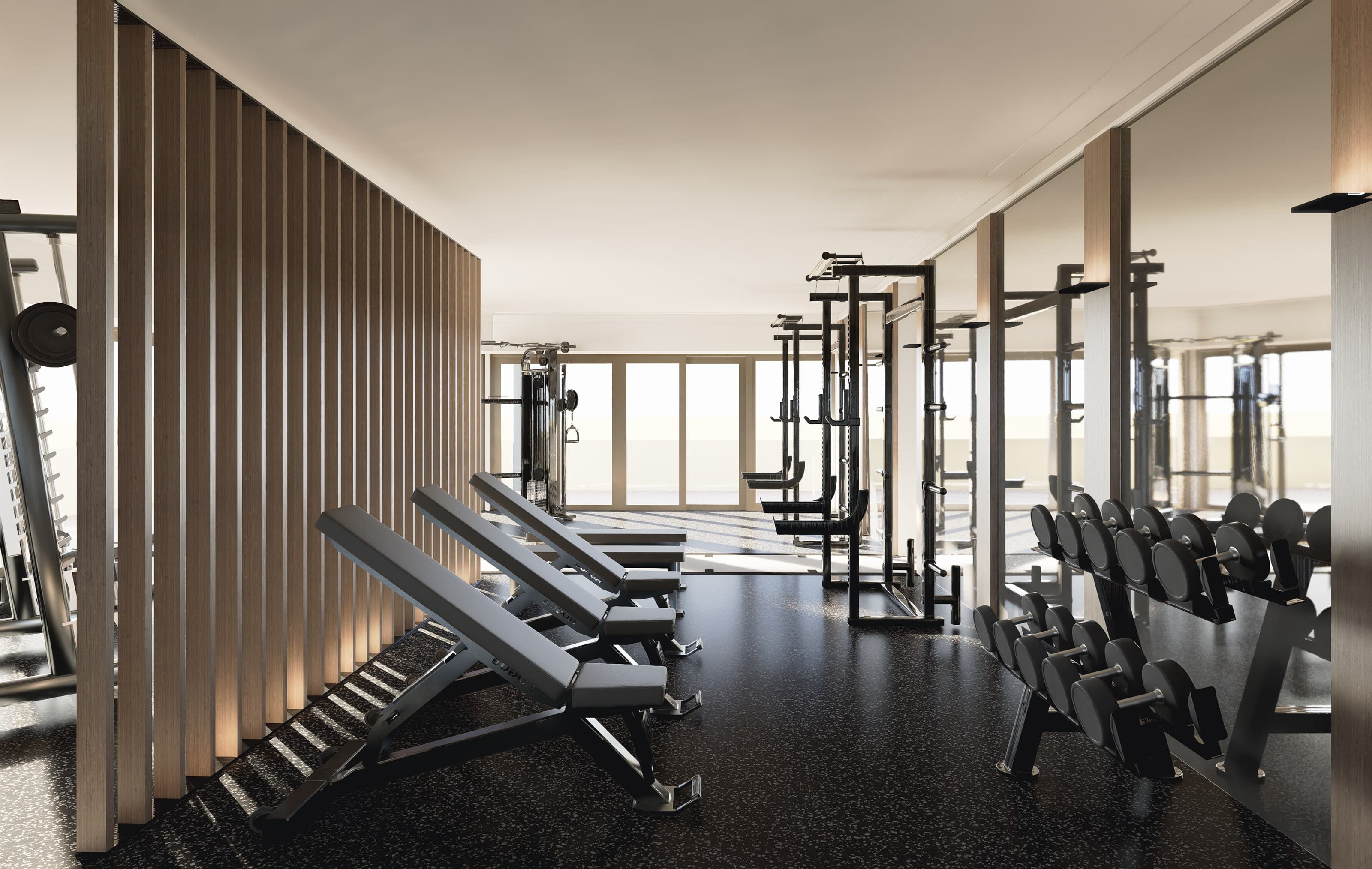 Render of unused incline benches, squat racks and a dumbbell stand beside a mirrored wall at Adapt, North Sydney