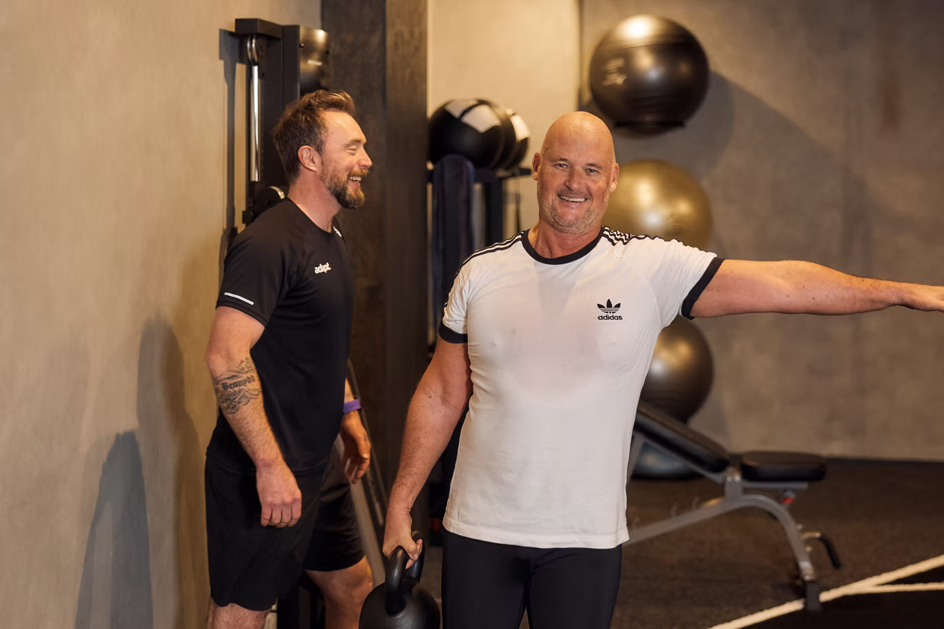 A coach training a client holding a kettlebell at Adapt, North Sydney